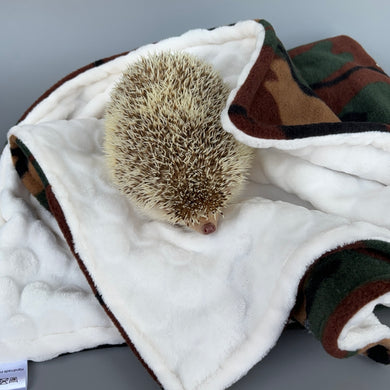 Camouflage fleece and beige bubble fleece handling blankets for small pets.