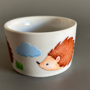Deep edge ceramic hedgehog food and water bowls.