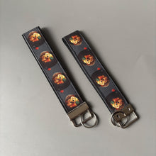 Load image into Gallery viewer, Reading hedgehog wristlet keychain. Hedgehog keyring. Hedgehog wrist strap keyring.