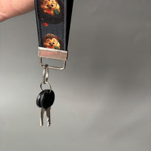 Load image into Gallery viewer, Reading hedgehog wristlet keychain. Hedgehog keyring. Hedgehog wrist strap keyring.