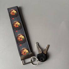 Load image into Gallery viewer, Reading hedgehog wristlet keychain. Hedgehog keyring. Hedgehog wrist strap keyring.