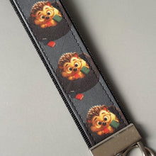 Load image into Gallery viewer, Reading hedgehog wristlet keychain. Hedgehog keyring. Hedgehog wrist strap keyring.