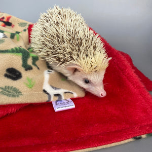 Dinosaur and red light cuddle fleece handling blankets for small pets.