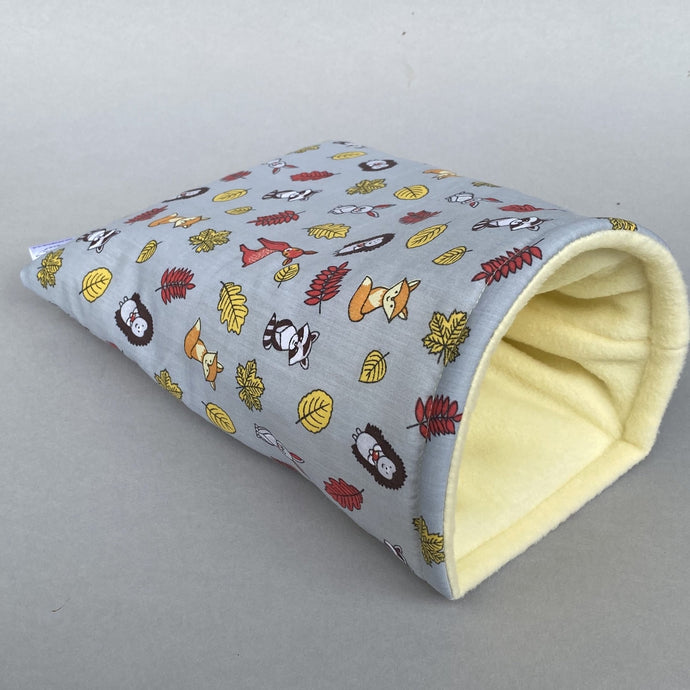 Grey and yellow woodland animals cosy snuggle cave. Padded stay open snuggle sack. Hedgehog bed. Fleece pet bedding.